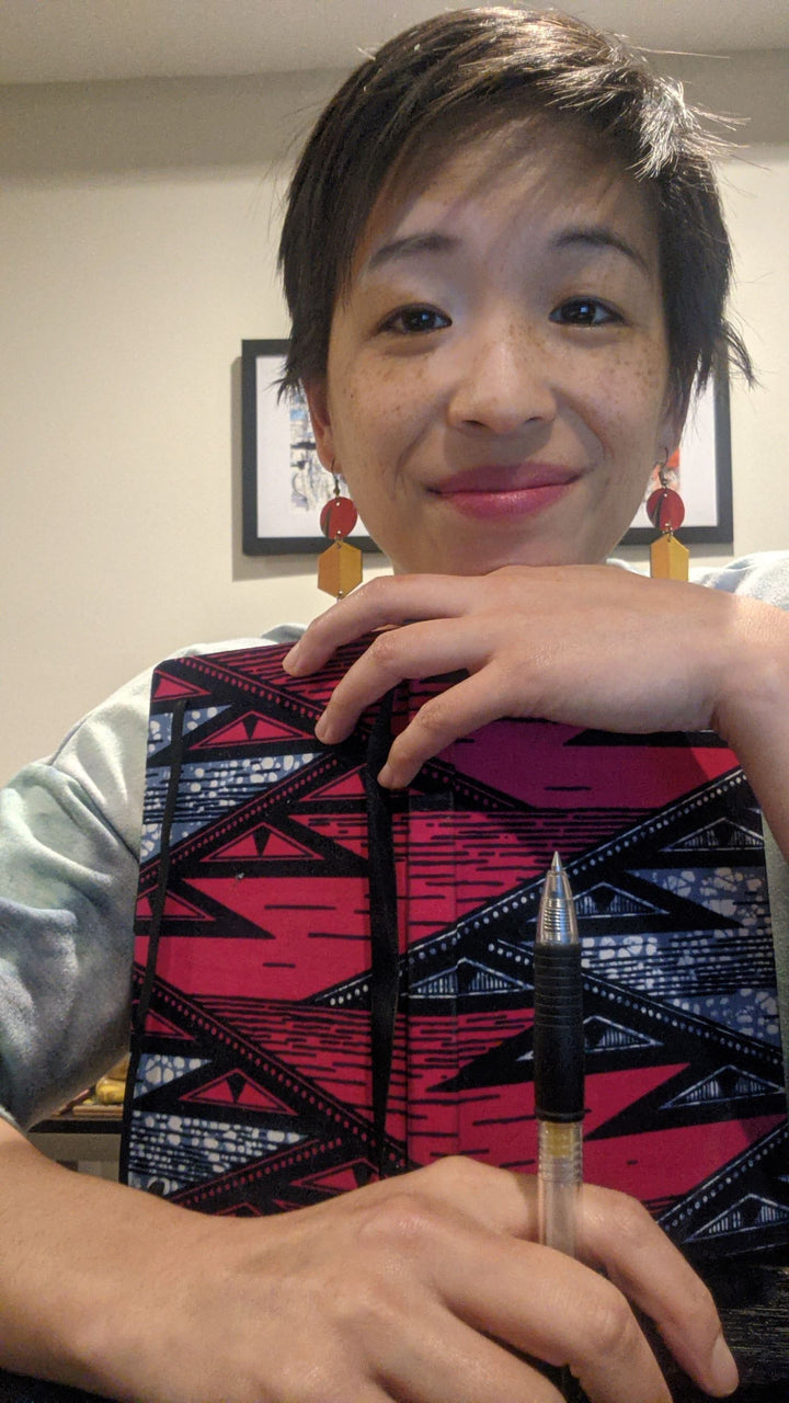Zenit founder Alina Liao with her custom wellness journal for self care journaling