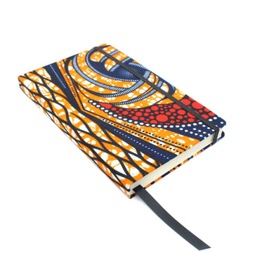 custom wellness journal for self care journaling by zenit journals with orange, red, and blue fabric print pattern cover